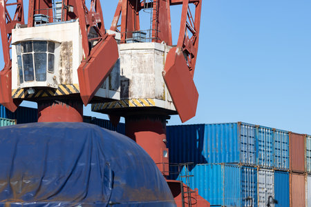 Lifting cranes and multi-colored cargo containers in the seaportの写真素材