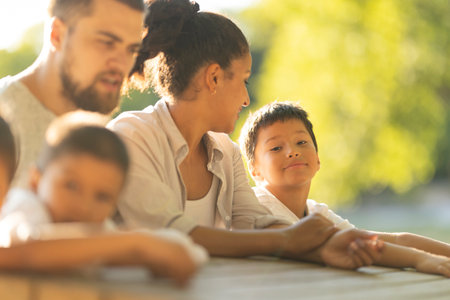 Happy family enjoying time together outdoors in a parkの写真素材
