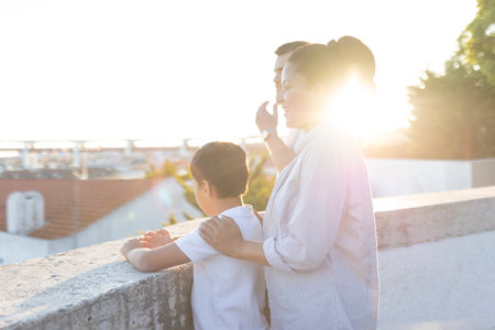 Family enjoying sunset over lisbon rooftops from viewpointの写真素材
