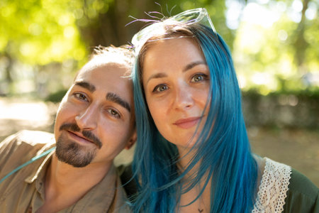 Young couple smiling together outdoors in parkの写真素材