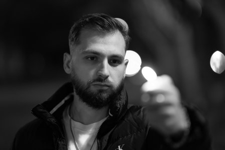 Young bearded man pointing finger at viewerの写真素材