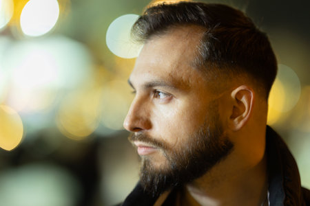 Young man looking ahead in urban nightの写真素材