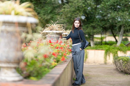 Woman posing in a lush green garden setting