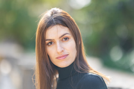 Young woman confidently looking at camera in parkの写真素材