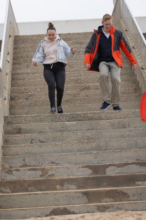 Young adults descending concrete stairs with energy