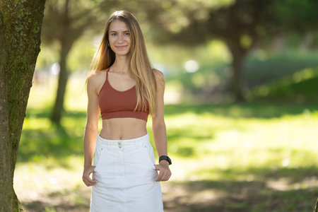 Young sporty woman smiling and posing in the parkの写真素材