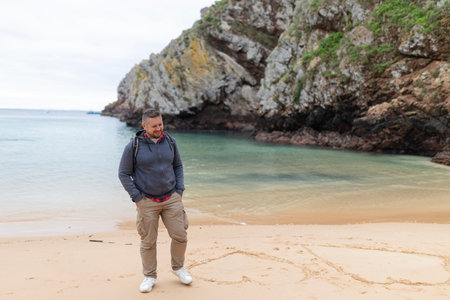 Man enjoying coastal walk on a sandy beach