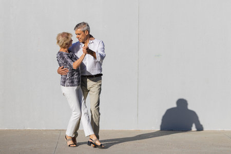 Senior couple dancing enjoying time together outdoorsの写真素材