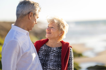 Senior couple sharing loving moment by the beach