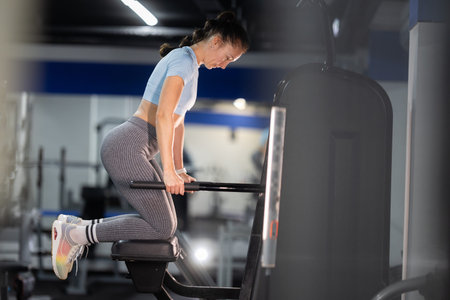 Woman exercising core strength on gym machine
