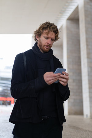 Young man using mobile phone in urban environmentの写真素材