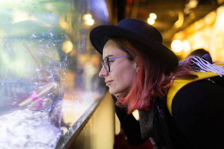 Woman admiring lobster in a seafood restaurant tank