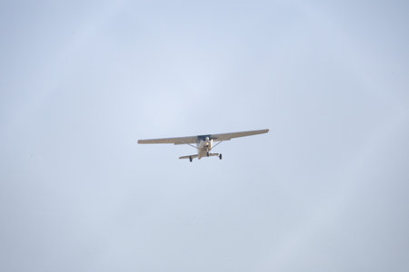 Small airplane flying in clear blue sky