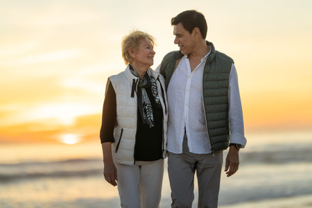 Couple enjoying romantic walk on beach during sunset