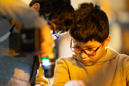 Boys concentrating on a learning and technology activityの写真素材