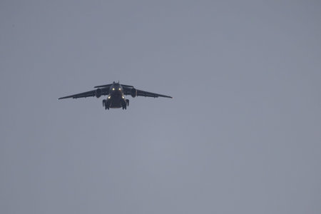 Cargo aircraft flying low with landing gear extended