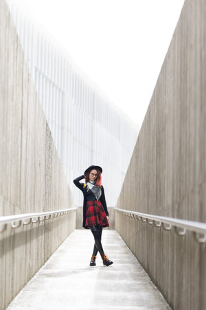 Young woman showing urban style in modern architectural setting