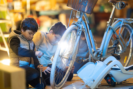Children learning bicycle repair and maintenance skillsの写真素材