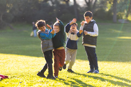 Children playing and blowing bubbles in park