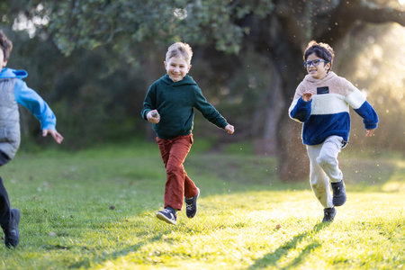 Happy boys running and playing in parkの写真素材