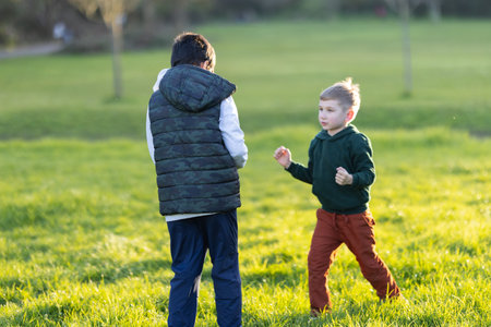 Little boy practicing moves with older brother
