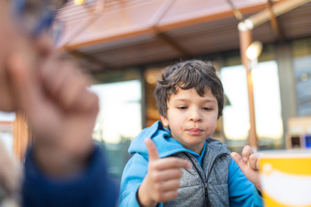 Young boy gesturing with finger during outdoor activity