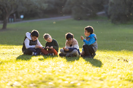 Boys playing together sharing a moment in parkの写真素材