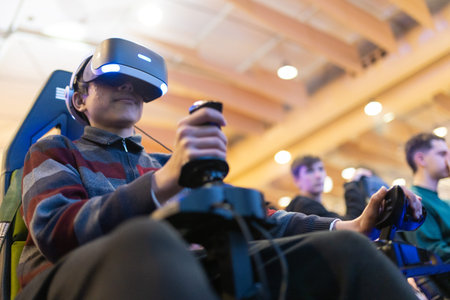 Young boy experiencing virtual reality simulation game