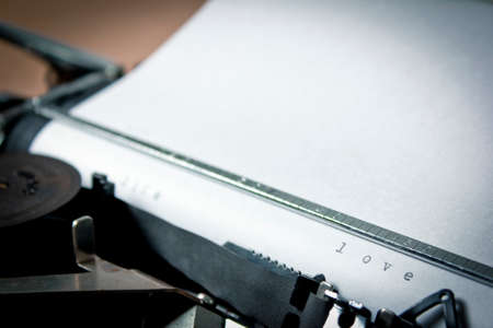 A closeup of an old fashioned typewriter with the words  LOVE  clearly visible の写真素材