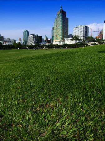 green golf and urban city architecture building downtown over blue skyの写真素材