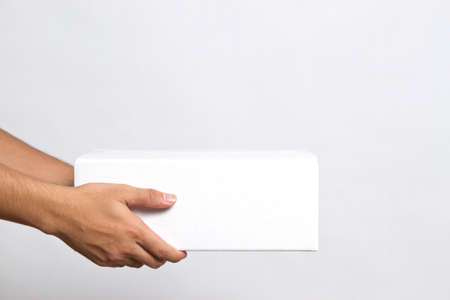 Hand of man, stretching out his hand to give the parcels boxesの写真素材