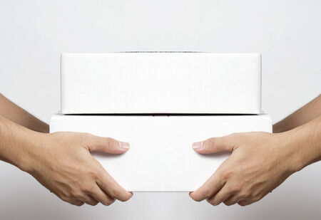 Hand of man, stretching out his hand to give the parcels boxesの写真素材