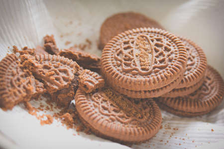 Chocolate chip cookies shot on white colored cloth, vintage style.の写真素材