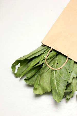 vegetables in paper grocery bag isolated over whiteの写真素材