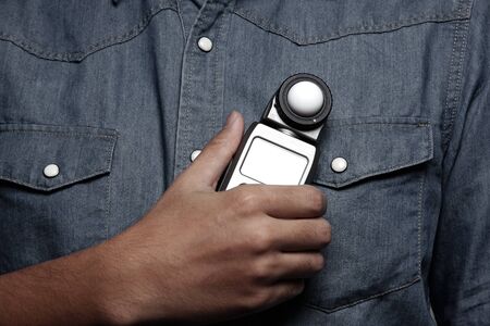 photographer holding a light meterの写真素材