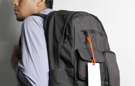 Young man with backpack isolate white background.