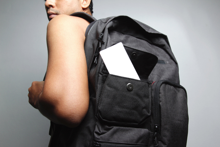 Young man with backpack isolate white background.の写真素材