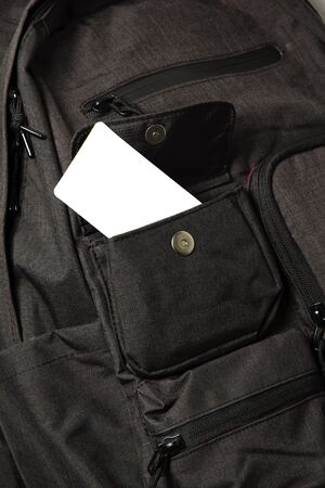 blank card in black backpack