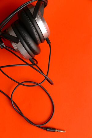 Headphones on orangge background.の写真素材