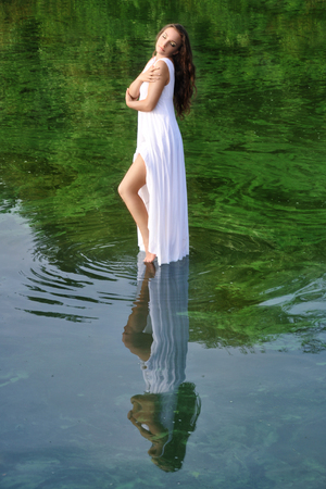Girl in white dress in waterの写真素材