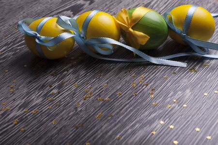 Yellow and green eggs on a wooden backgroundの写真素材