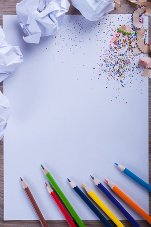 Colored pencils on white paper, man, hand, back to school concept - white letter sheet with pencils and filingsの写真素材