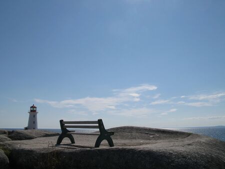 Bench with lighthouse at Peggy´s Cove, Nova Scotiaの写真素材