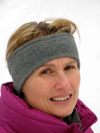 Young Lady with Headband in winter, looking thoughtfully into cameraの写真素材
