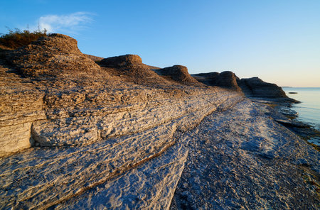 Byrums Raukar, Oeland, Sweden, spectacular tower formation created by limestone eroded of water, sunny evening with blue skyの写真素材