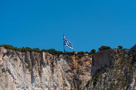 Greece national flag on a cliffのeditorial素材