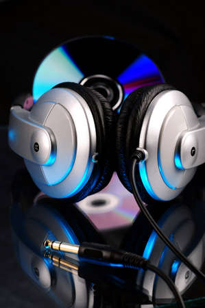 Headphones and compact disk with reflectionの写真素材