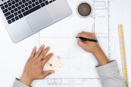 Engineer person working to building design concept with laptop computer. Top view from above with copy space.の写真素材