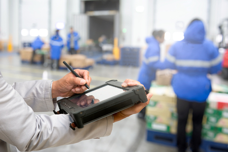 Bluetooth barcode scanner checking goods in warehouseの写真素材