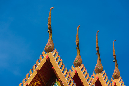 the statue on temple roof in thailandの写真素材